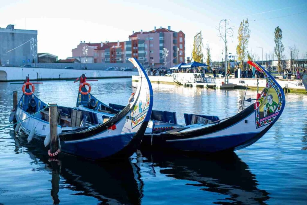 Traditional colorful moliceiro boats floating on a canal in Aveiro Portugal