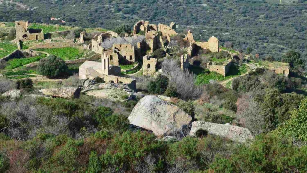 Ruins of a historic stone settlement surrounded by green countryside in Portugal