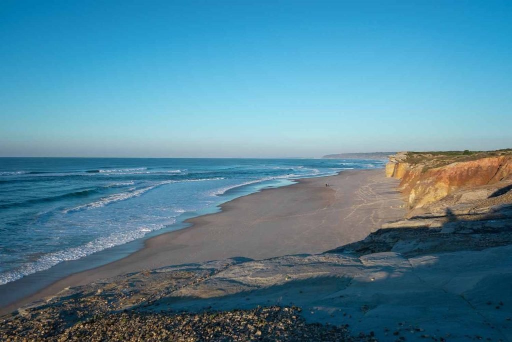 Wide sandy beach and ocean waves at Praia da Comporta in Portugal