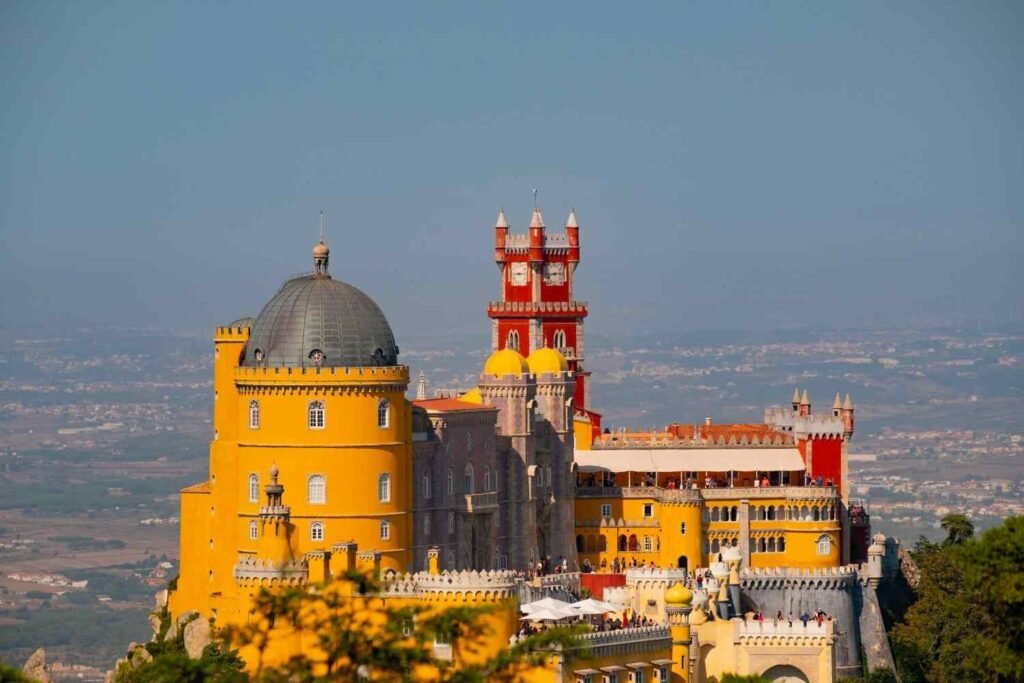Colorful Pena Palace perched on a green hill in Sintra, Portugal.