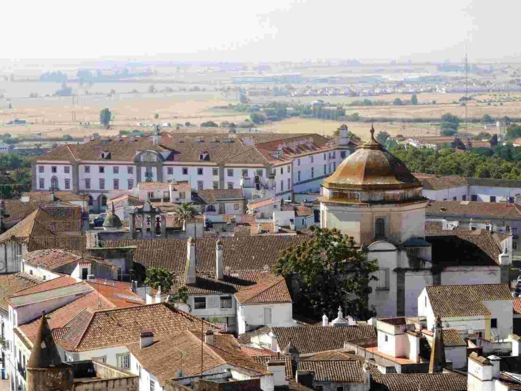 Historic white buildings and terracotta rooftops in Evora Portugal