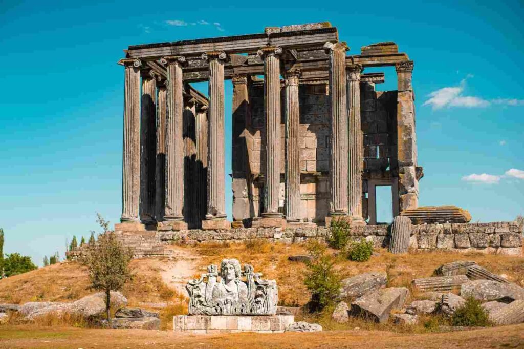 Ancient Roman Temple ruins in Évora, Portugal, under a clear blue sky.